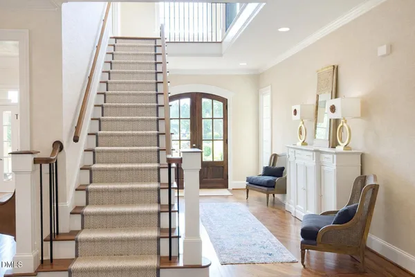 a view of entryway and hall with wooden floor