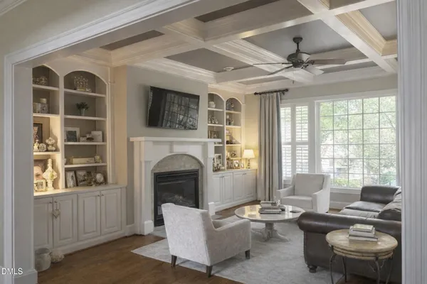a living room with fireplace furniture and a large window