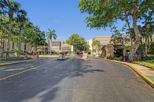 a view of road with card parked on side and road