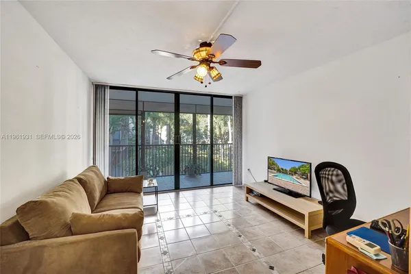 a living room with furniture and a floor to ceiling window