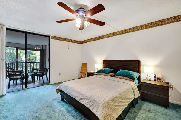 a bedroom with bed and a flat screen tv