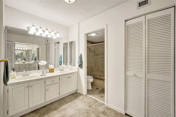 a bathroom with a shower and a sink