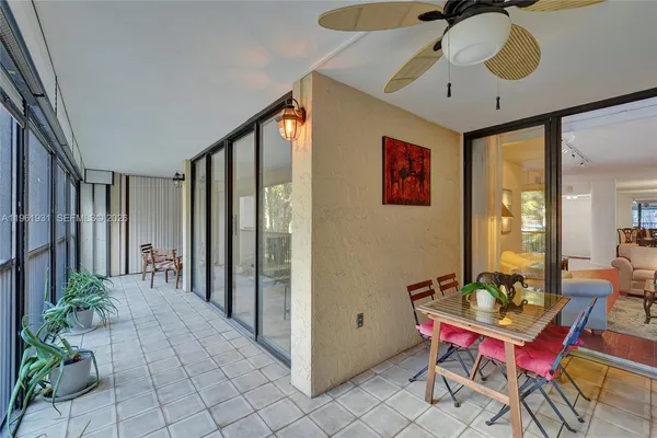 a bedroom with furniture and large windows