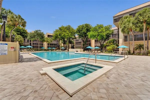 a view of a swimming pool with an outdoor seating