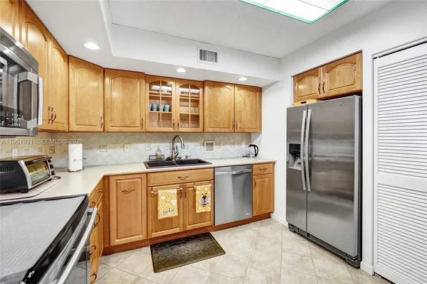 a kitchen with stainless steel appliances granite countertop a sink a stove and cabinets