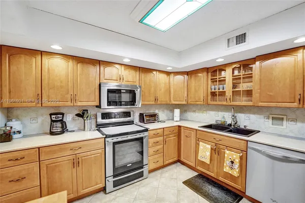 a kitchen with stainless steel appliances granite countertop a stove and a sink