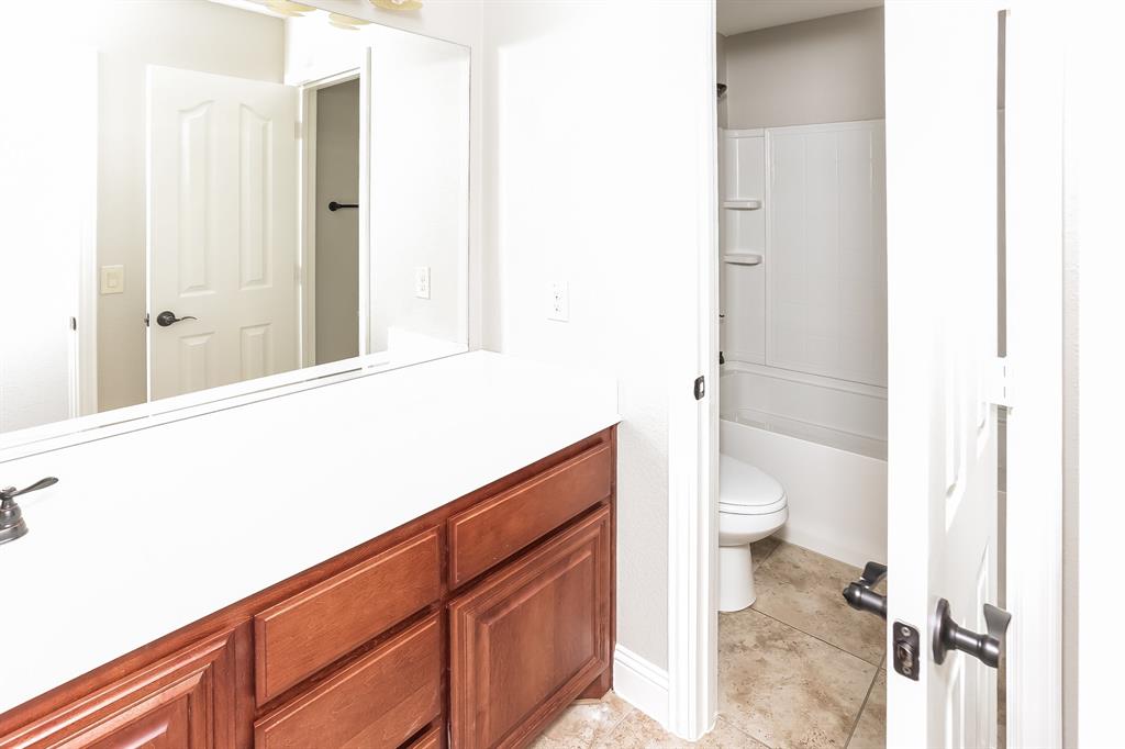 921 Lucetta Street Midlothian, TX 76065 - Photo 13 of 15 a bathroom with a sink a toilet and shower