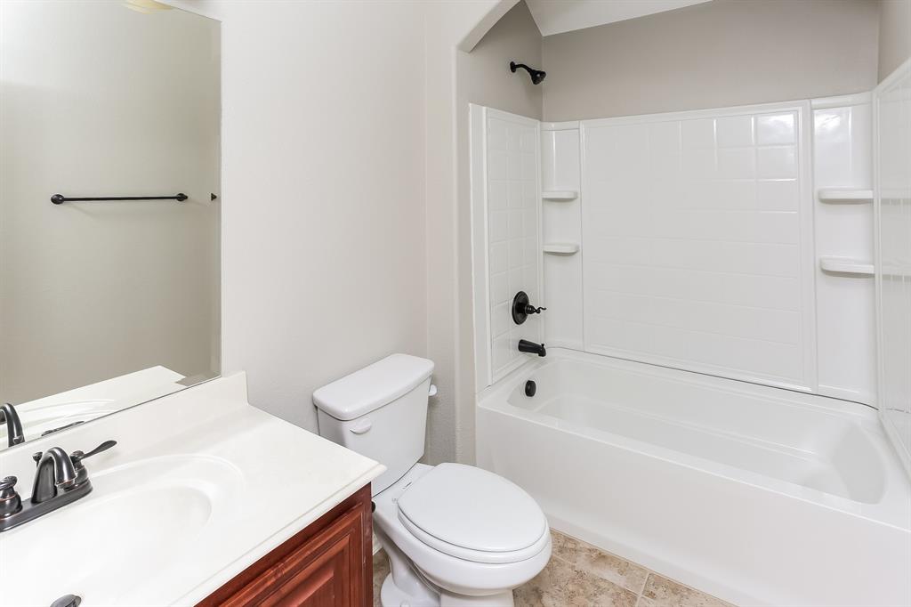 921 Lucetta Street Midlothian, TX 76065 - Photo 14 of 15 a white toilet sitting next to a bath tub