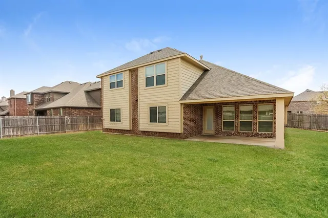 a view of a house with a yard and sitting area