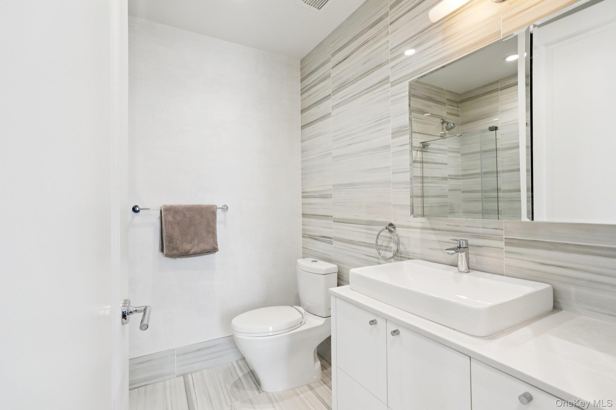 175 Huguenot Street, Unit PH302 New Rochelle, NY 10801 - Photo 14 of 25 a bathroom with a sink toilet and shower