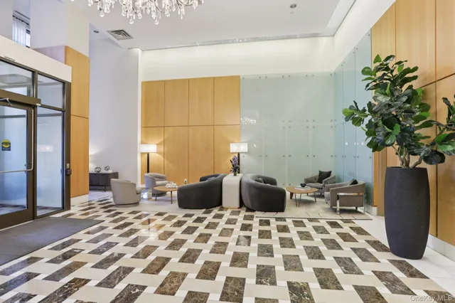 a living room with a couch and a potted plant