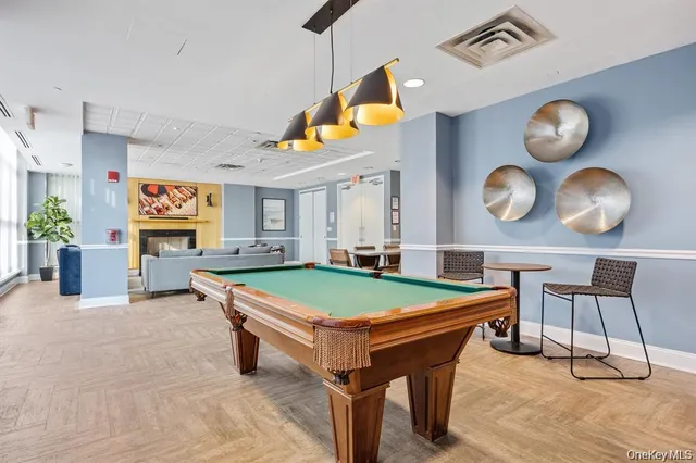 a room with pool table and windows