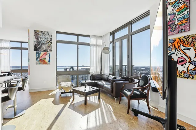 a living room with furniture and a floor to ceiling window