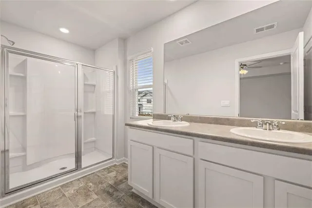 a bathroom with a granite countertop sink mirror and double