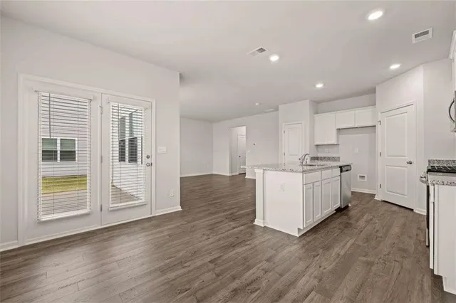 a view of kitchen with wooden floor and electronic appliances