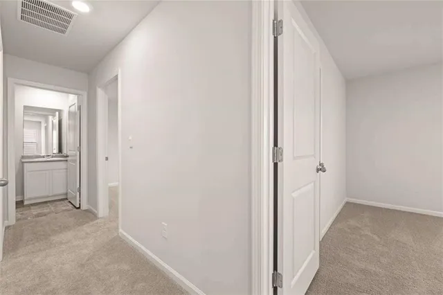 a view of a hallway with a wooden cabinets
