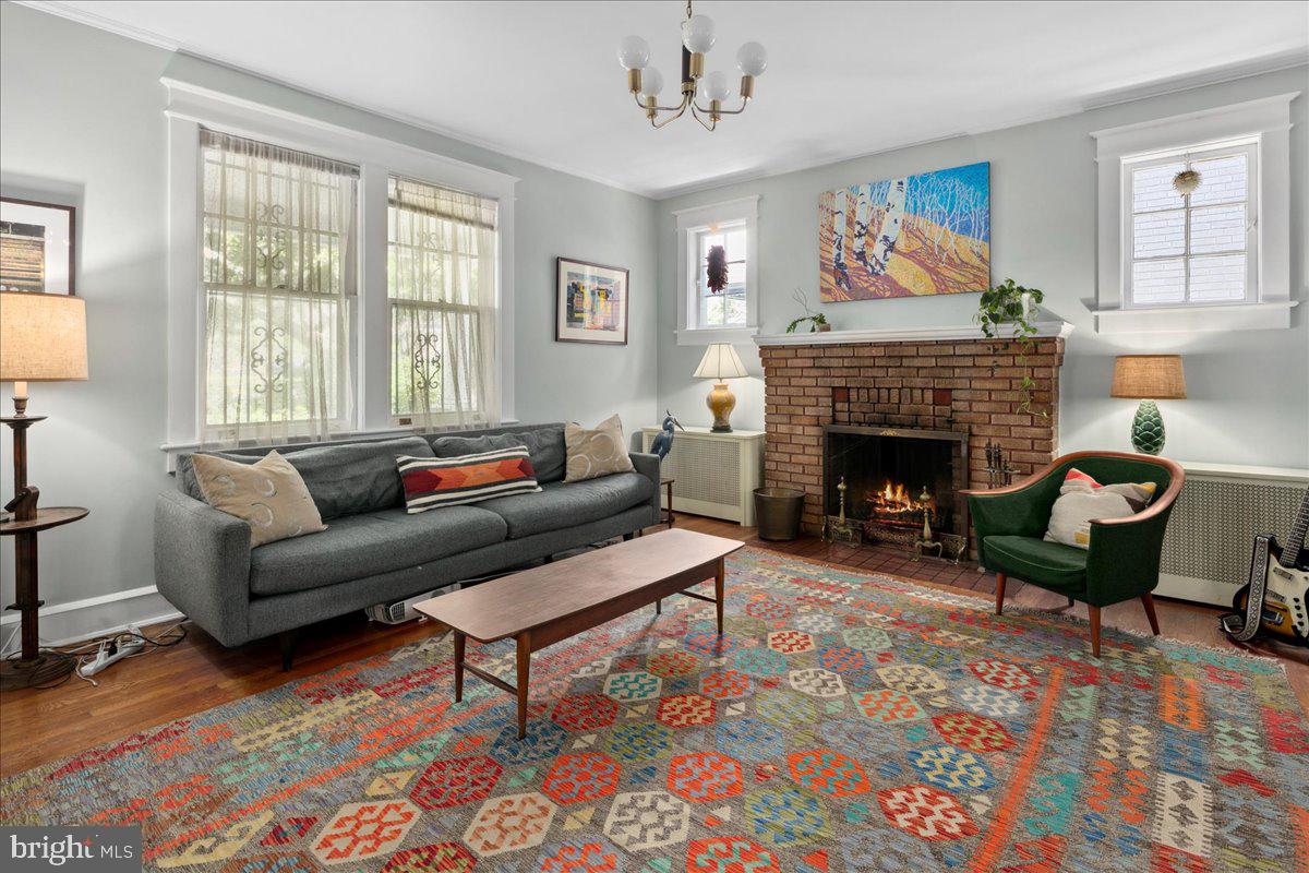 6721 Piney Branch Road Northwest Washington, DC 20012 - Photo 18 of 78 a living room with furniture a rug and a fireplace