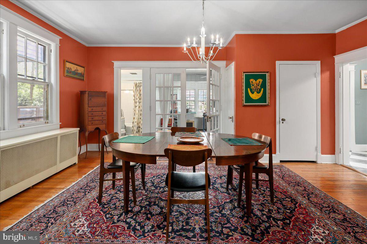 6721 Piney Branch Road Northwest Washington, DC 20012 - Photo 24 of 78 a dining room with furniture a rug and a chandelier
