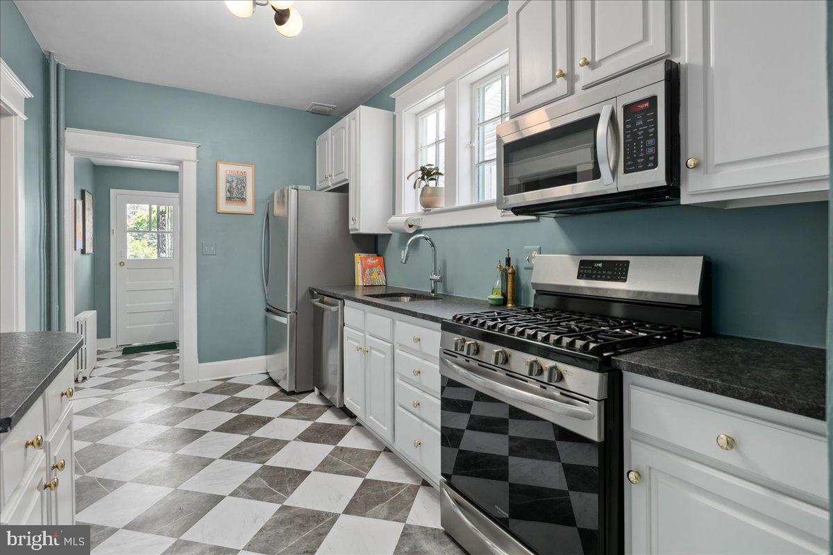 6721 Piney Branch Road Northwest Washington, DC 20012 - Photo 33 of 78 a kitchen with stainless steel appliances granite countertop a stove top oven a sink dishwasher a refrigerator and cabinets