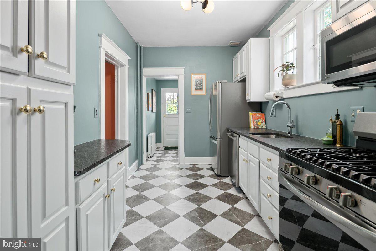 6721 Piney Branch Road Northwest Washington, DC 20012 - Photo 34 of 78 a kitchen with stainless steel appliances a stove a sink and a microwave