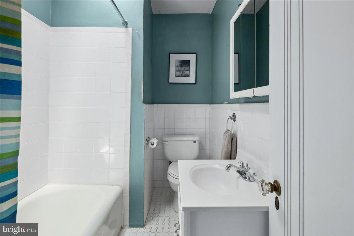 6721 Piney Branch Road Northwest Washington, DC 20012 - Photo 49 of 78 a bathroom with a sink and mirror with bathtub