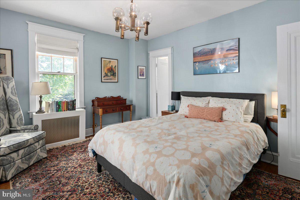 6721 Piney Branch Road Northwest Washington, DC 20012 - Photo 54 of 78 a bedroom with a large bed and a chandelier