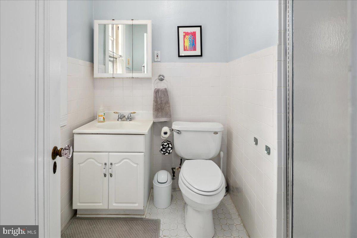 6721 Piney Branch Road Northwest Washington, DC 20012 - Photo 57 of 78 a white toilet sitting next to a bathroom sink