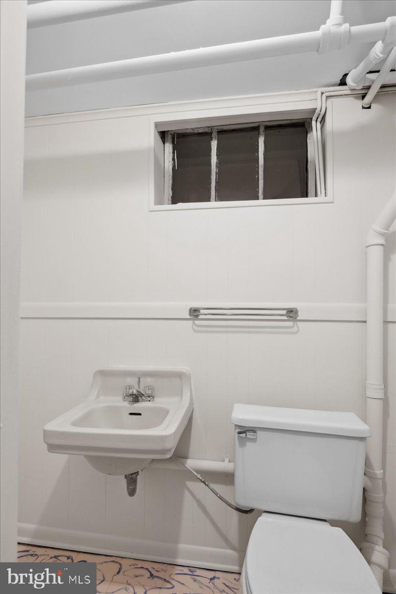 6721 Piney Branch Road Northwest Washington, DC 20012 - Photo 65 of 78 a bathroom with a sink a toilet and mirror