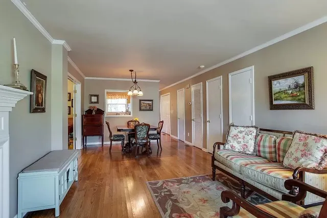a living room with furniture fireplace and window