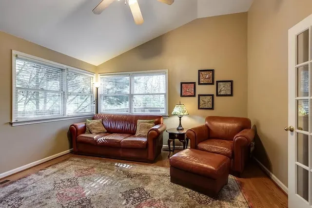 a living room with furniture rug and wooden floor