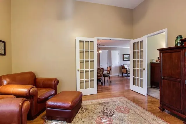 a living room with furniture and a wooden floor