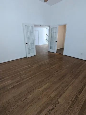 a view of empty room with wooden floor