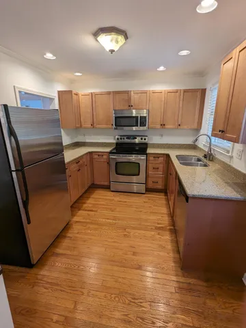 a kitchen with a sink stove and refrigerator