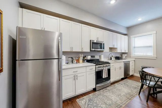 a kitchen with a refrigerator stove and microwave