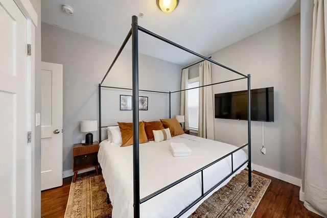 a bed room with a bed and a television