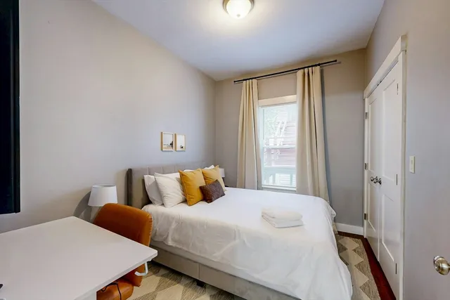 a bedroom with a bed and a window