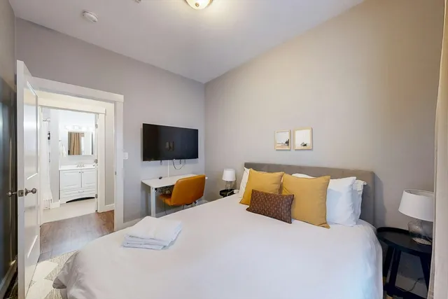 a bedroom with a bed and a flat screen tv