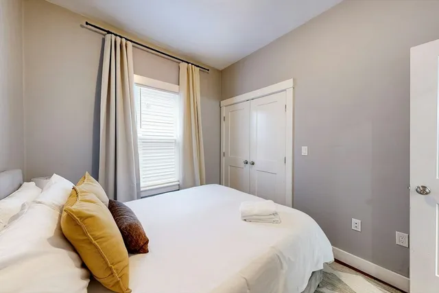 a bedroom with a bed and a window