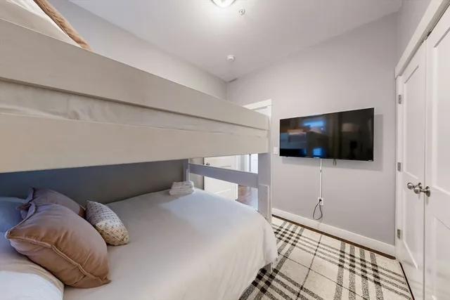 a bedroom with a bed and a flat screen tv