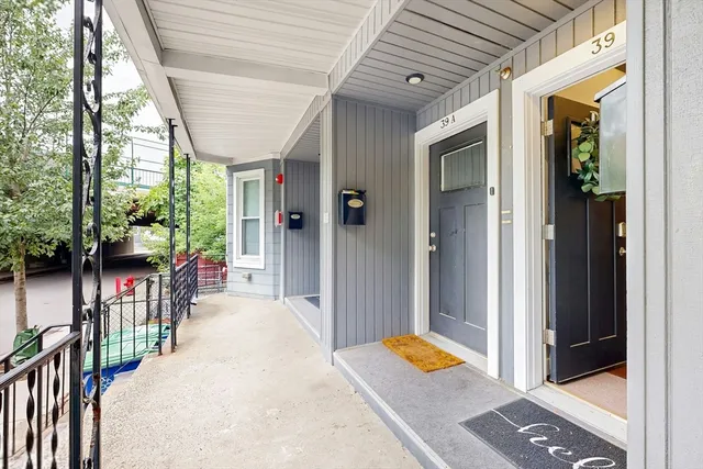 a front view of a house with outdoor seating