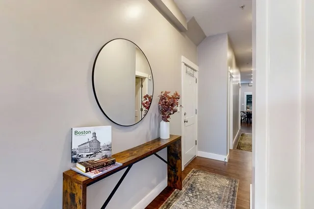 a front view of a house with wooden floor and a potted plant