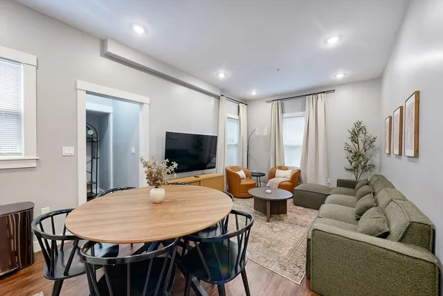 a outdoor space with furniture a flat screen tv and a view of kitchen