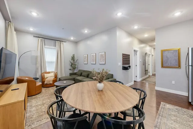 a dining room with furniture and window