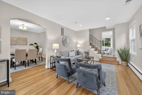 a living room with fireplace furniture and a wooden floor