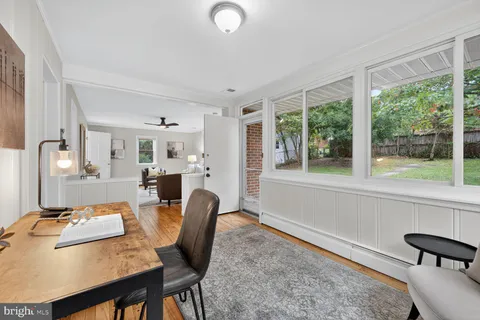 a dining room with furniture and a window