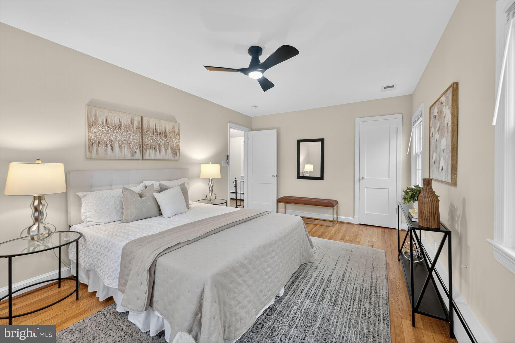 2813 Laurel Avenue Cheverly, MD 20785 - Photo 18 of 30 a spacious bedroom with a bed and a lamp