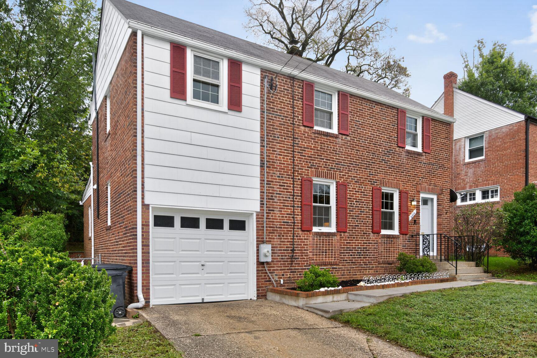 2813 Laurel Avenue Cheverly, MD 20785 - Photo 2 of 30 a front view of a house with a yard and garage
