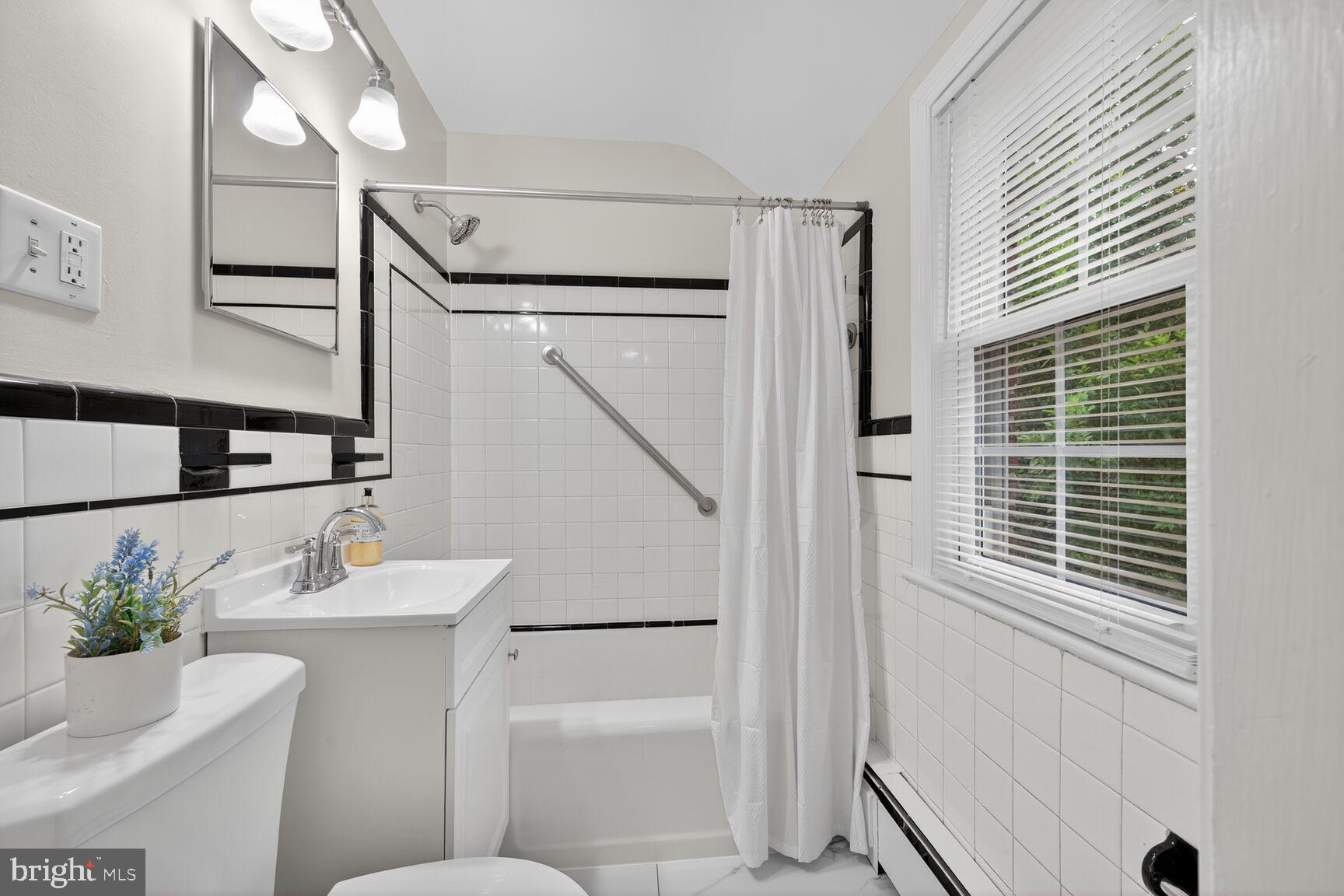 2813 Laurel Avenue Cheverly, MD 20785 - Photo 24 of 30 a bathroom with a sink toilet and shower