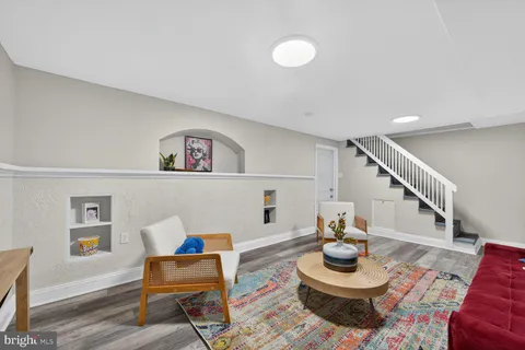 a living room with furniture and a wooden floor