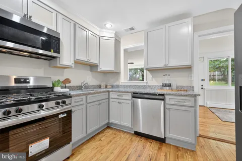a kitchen with stainless steel appliances granite countertop a stove and a sink